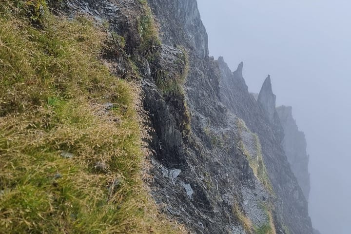 The crux point - transitioning over the knife edge from SW to NE side with drop off