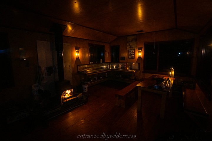 Grassy Flat hut, lit with fire