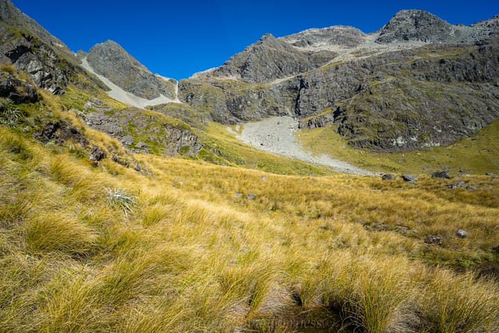Heading across the tussock to find easier terrain to ascend